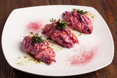 Salad with beets and pork on plate