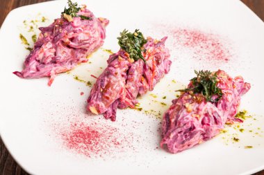 Salad with beets and pork on plate