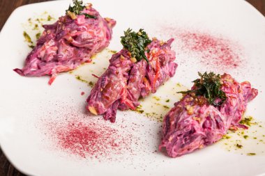 Salad with beets and pork on plate