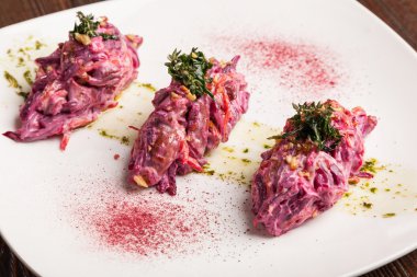 Salad with beets and pork on plate