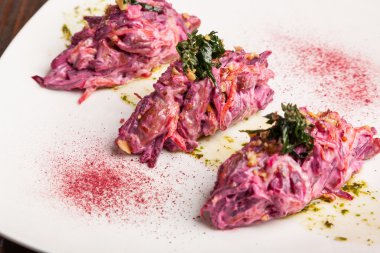 Salad with beets and pork on plate