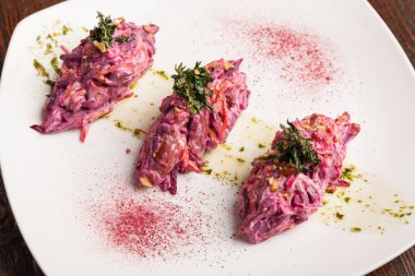 Salad with beets and pork on plate