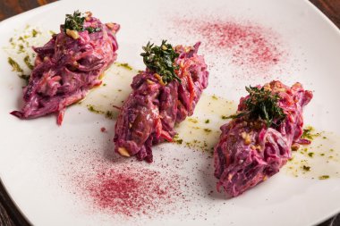 Salad with beets and pork on plate