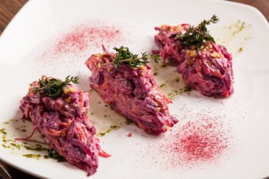Salad with beets and pork on plate