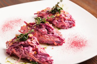 Salad with beets and pork on plate