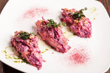 Salad with beets and pork on plate