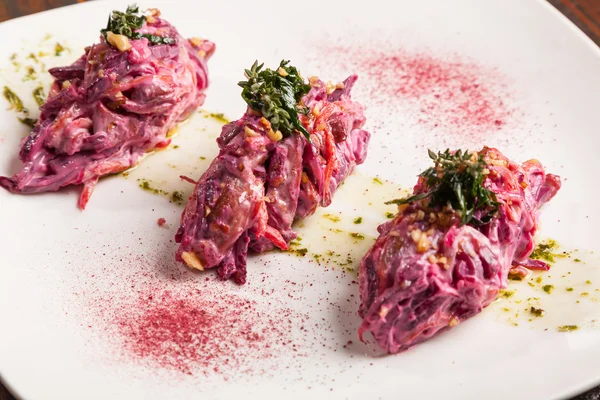 Salad with beets and pork on plate