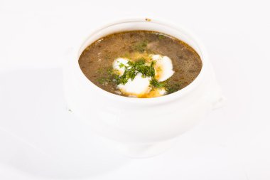 Beyaz tabakta ekşi kremalı lahana çorbası.