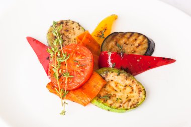 Beyaz tabakta patlıcan ve kabakla ızgara sebze.