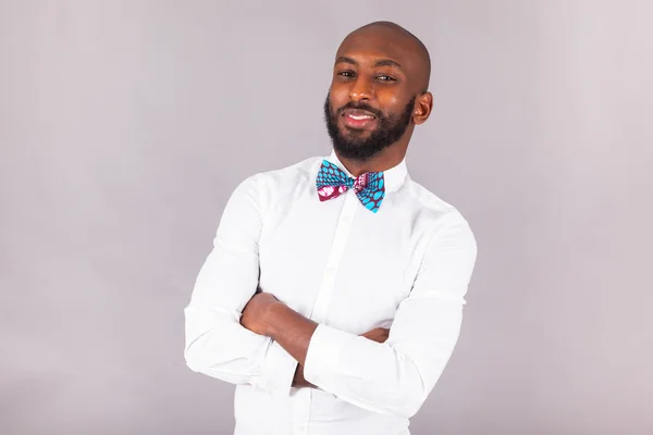 African American young man with folded arms wearing a bow tie — Stock Photo, Image