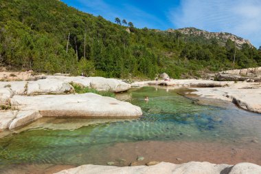 Cavu natural pool near Tagliu Rossu and Sainte Lucie in Corsica  clipart