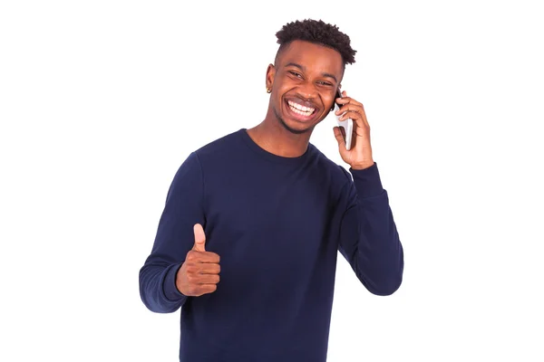 Joven afroamericano sosteniendo un teléfono inteligente pulgares hacia arriba —  Fotos de Stock