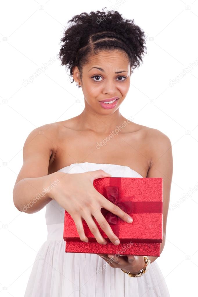 Disappointed young African American woman opening a gift box