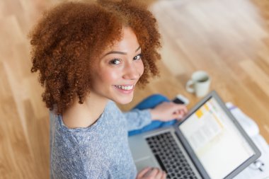 Bir dizüstü bilgisayar kullanan Afro-Amerikan öğrenci kız