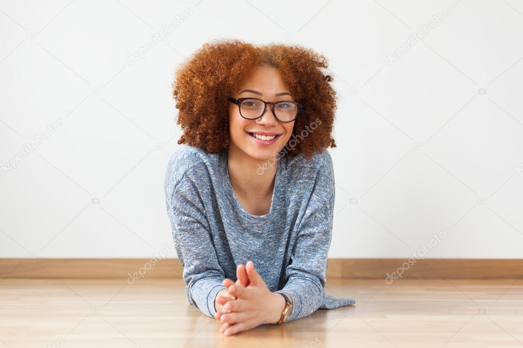 African American teenage girl lying down on floor