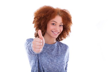 Young hispanic teenage girl making thumbs up gesture