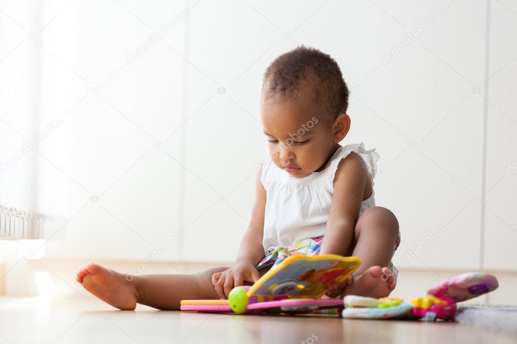 African American little girl sitting on the floor