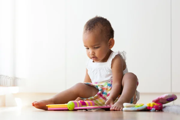 Portrét africké americké malé holčičky sedící na f — Stock fotografie