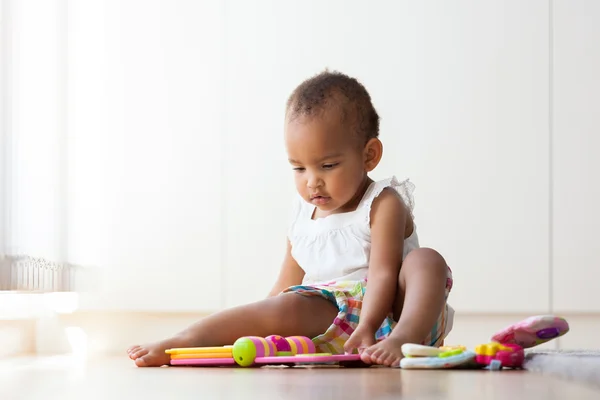 Portrait of little African American little girl sitting on the f — Stock Photo, Image