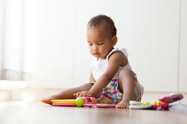 Portrait of little African American little girl sitting on the f — Stock Photo, Image