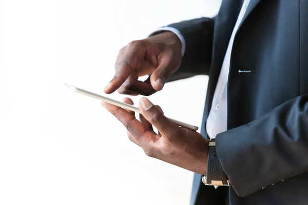 Africano americano homem de negócios usando um tablet tátil sobre branco — Fotografia de Stock