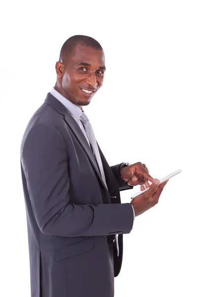 African american business man using a tactile tablet over white — Stock Photo, Image