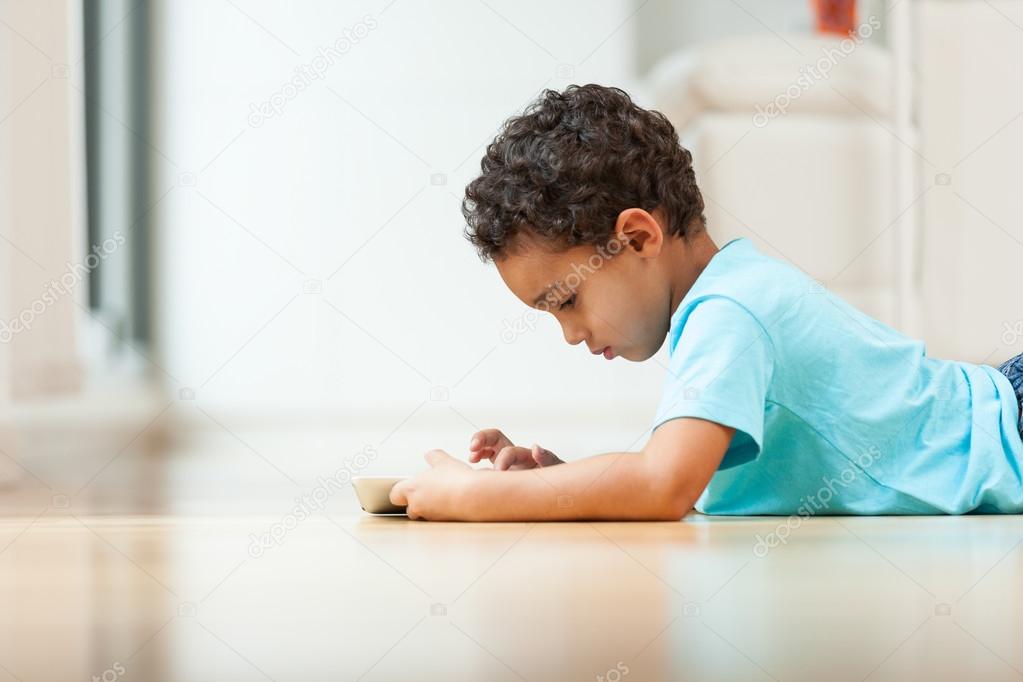 African american little boy using a tactile tablet