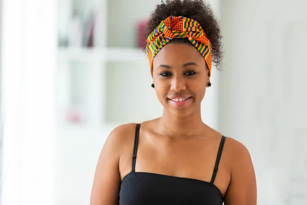 Beautiful African American woman wearing an african head scarf - — Stock Photo, Image