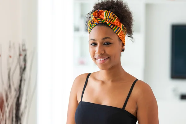 Beautiful African American woman wearing an african head scarf - — Stock Photo, Image