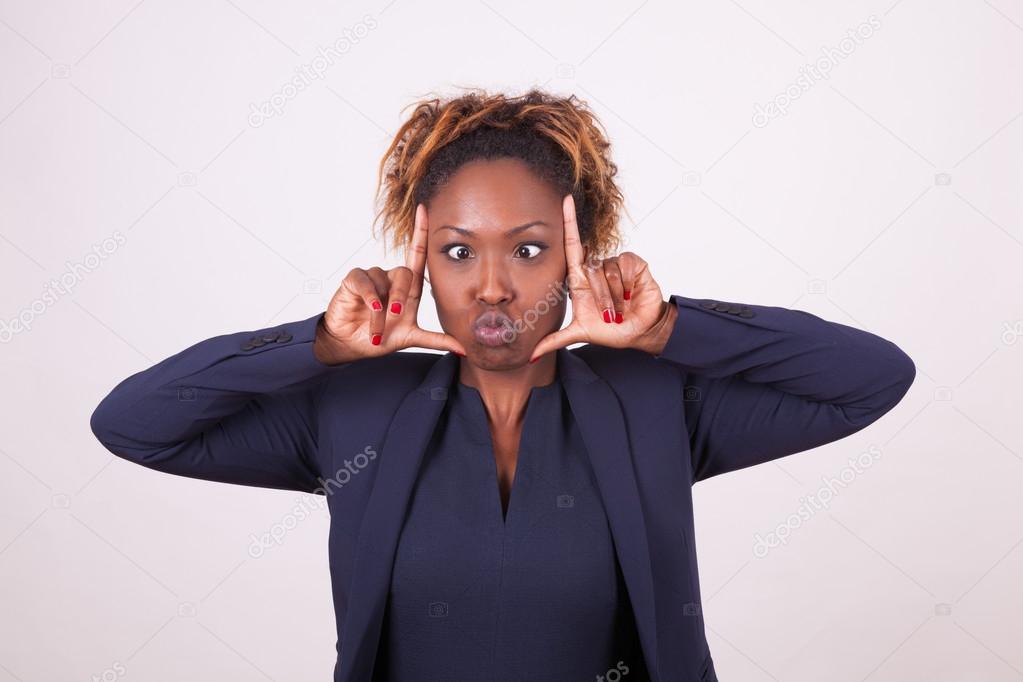 African American business woman grimacing making frame gesture w