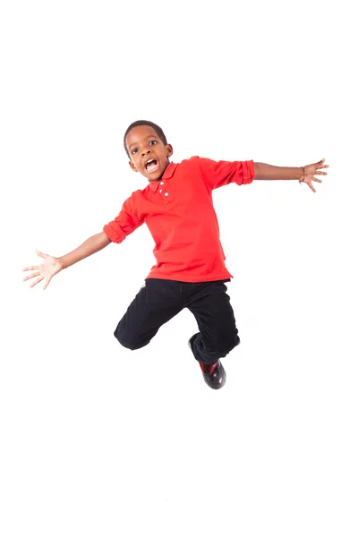 Portrait of a cute african american little boy jumping, isolated — Stock Photo, Image