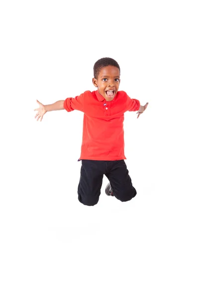 Portrait of a cute african american little boy jumping, isolated — Stock Photo, Image