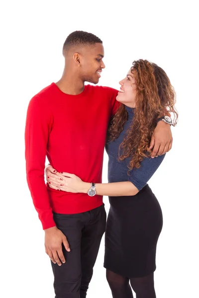 Happy mixed race couple hugging over a white background — Stock Photo, Image