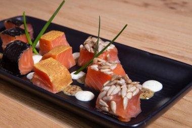 Siyah tabakta marine etmek için dilimlenmiş somon aperatifleri