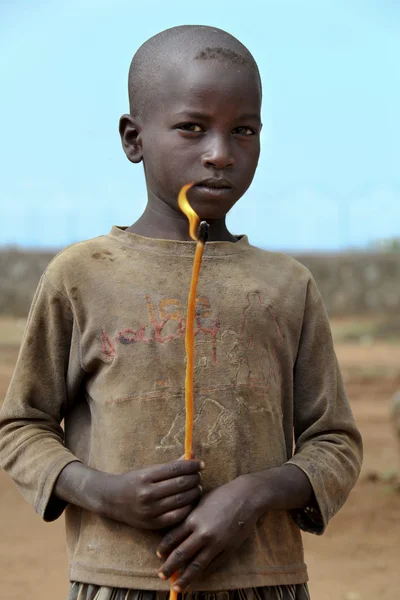 Portrait of the african boy with the burning candle in hands — Stock Photo, Image