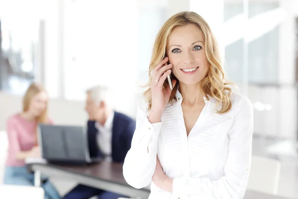 Attractive businesswoman making a call — Stock Photo, Image