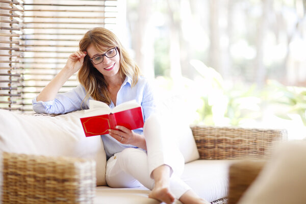 Woman reading book at home 