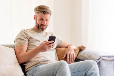 Evdeki kanepede oturan yakışıklı bir adamın fotoğrafı ve kısa mesaj.. 