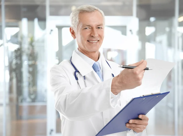 Male doctor with stethoscope and clipboard Stock Photo