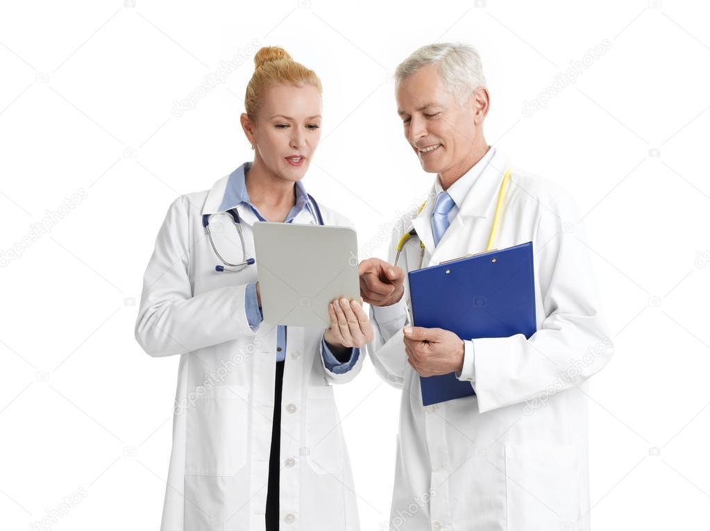 Doctors with tablet and clipboard