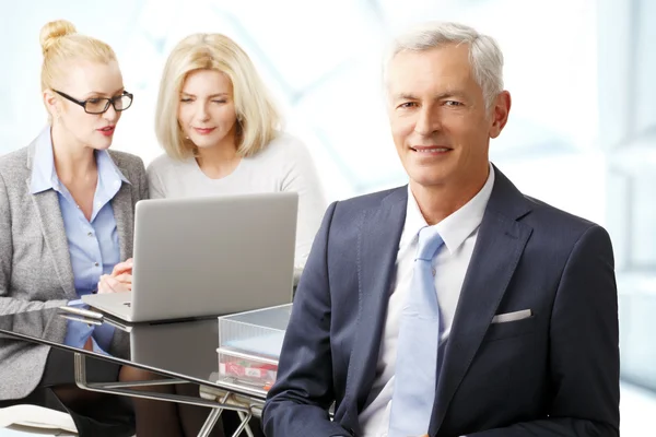Businessman with women on background — Stock Photo, Image