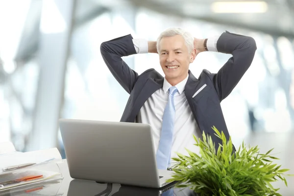 Businessman sits back and relaxing