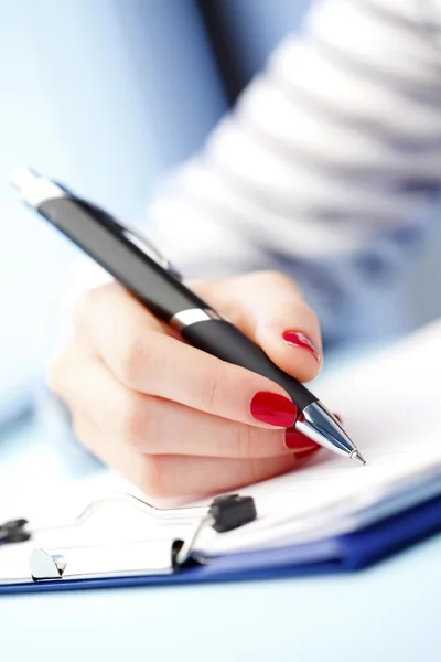 Female hand with pen Stock Photo