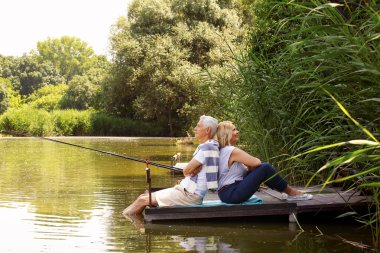 Happy old age couple fishing
