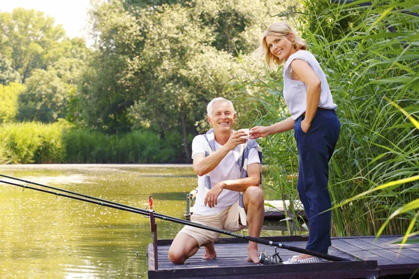 Happy senior couple fishing — Stock Photo, Image