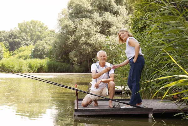 Happy senior couple fishing — Stock Photo, Image