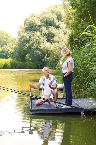 Senior couple relaxing and fishing — Stok fotoğraf