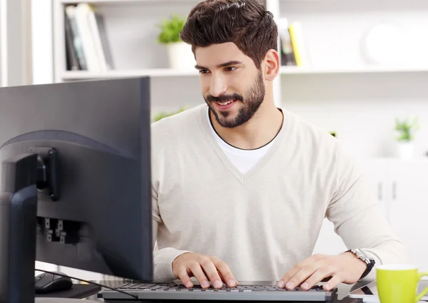 Young businessman near computer