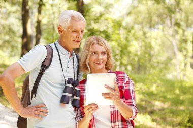 Active retired people are hiking.