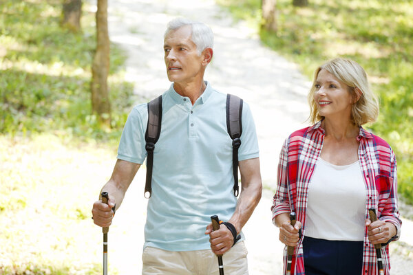 Active senior couple walking  in the forest